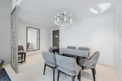 a dining room with a table and chairs at Modern 2-Bedroom Apartment Near Burj Khalifa & Dubai Mall in Dubai