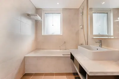a white bathroom with a tub and a sink at Modern 2-Bedroom Apartment Near Burj Khalifa & Dubai Mall in Dubai