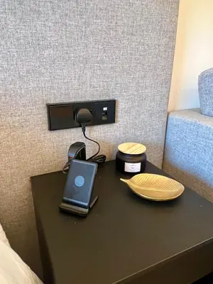 a table with a laptop and a charger on a bed at Palm Jumeirah, Studio, Fantastischer Meer-, Beach- und Skyline Blick, Strand in Dubai