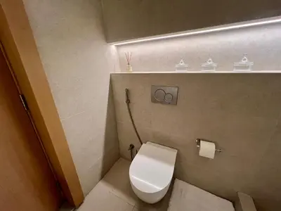 a bathroom with a toilet with a light above it at Palm Jumeirah, Studio, Fantastischer Meer-, Beach- und Skyline Blick, Strand in Dubai