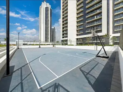 a basketball court on the roof of a building at Cozy Golf & Lake View 1BR Apartment,Damac Hills 1 in Dubai