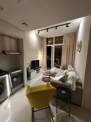 a living room with a couch and a yellow chair at Cozy Golf & Lake View 1BR Apartment,Damac Hills 1 in Dubai