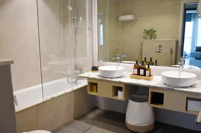 a bathroom with two sinks and a shower at Luxury Dubai High Rise, Skyline Views in Dubai