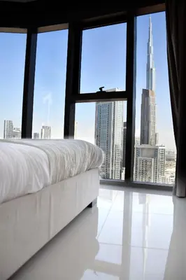 a bedroom with a bed and a view of a city at Luxury Dubai High Rise, Skyline Views in Dubai