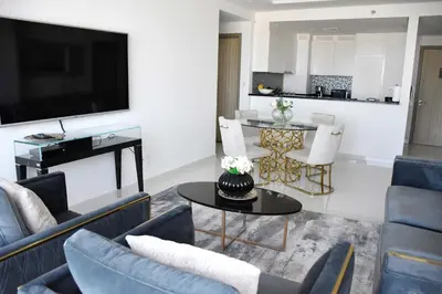 a living room with couches and a tv and a table at Luxury Dubai High Rise, Skyline Views in Dubai