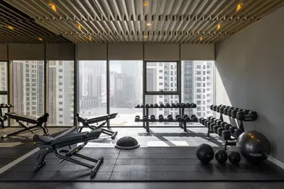 a gym with exercise equipment in a large building at Luxury Dubai High Rise, Skyline Views in Dubai