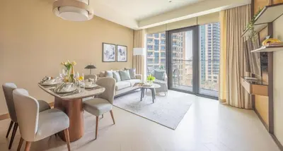 a living room with a couch and a table at Frank Porter - Address Opera in Dubai