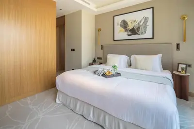 a hotel room with a large bed with a tray on it at Frank Porter - Address Opera in Dubai