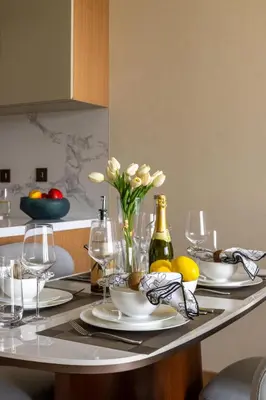 a table with plates and wine glasses and flowers on it at Frank Porter - Address Opera in Dubai