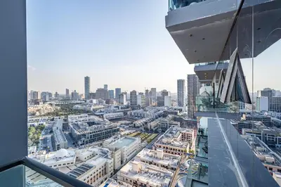 a view of a city from the top of a building at Superhost - Bright & Stylish 1-Bedroom in Bloom Tower, JVC in Dubai