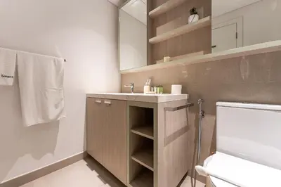 a bathroom with a sink and a toilet and a mirror at HAVN - 1 Bedroom in Harrington House, JVC in Dubai