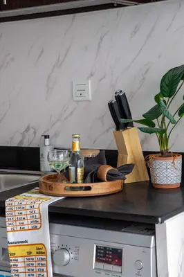 a counter top with a bottle of wine and glasses at Frank Porter - Hanover Square in Dubai