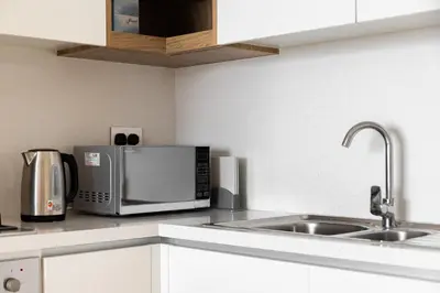 a kitchen counter with a microwave and a sink at downtown views 1108 burj in Dubai