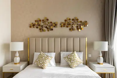 a bedroom with a large bed with two nightstands and two lamps at downtown views 1108 burj in Dubai