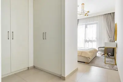 a bedroom with white cabinets and a bed at downtown views 1108 burj in Dubai