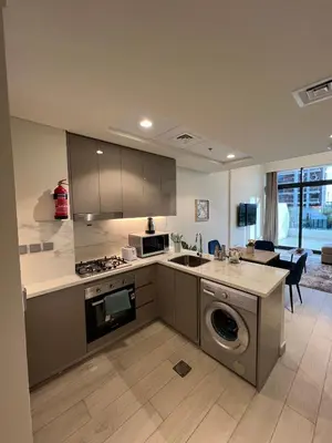 a kitchen with a sink and a stove top oven at Special Offer Rental One Bedroom Apartment at Azizi Riviera Dubai in Dubai