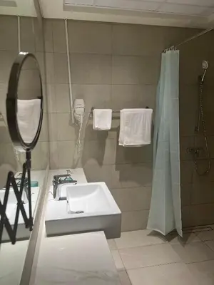 a bathroom with a sink and a mirror and a shower at Special Offer Rental One Bedroom Apartment at Azizi Riviera Dubai in Dubai
