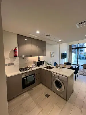 a kitchen with a sink and a stove top oven at Special Offer Rental One Bedroom Apartment at Azizi Riviera Dubai in Dubai