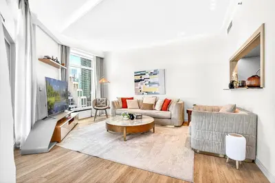 a living room with a couch and a table at Trendy 2BR Direct Mall Access Burj View High Floor in Dubai