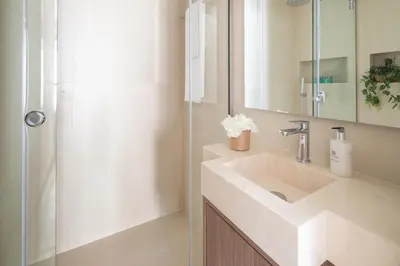 a bathroom with a sink and a shower at Frank Porter - Escan Tower in Dubai