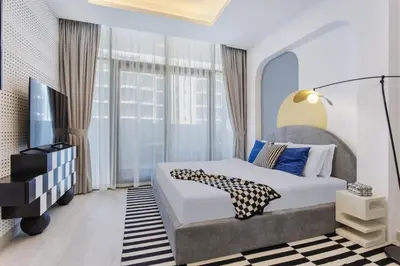a bedroom with a bed and a large window at Modern Boutique Studio with Burj Khalifa View in Dubai
