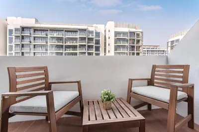 two chairs and a table on a balcony with buildings at Modern Boutique Studio with Burj Khalifa View in Dubai