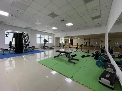a gym with treadmills and exercise equipment on the floor at Stunning Hideaway in Dubai Marina in Dubai