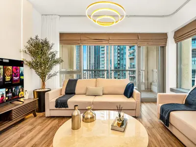 a living room with a couch and a table at Royal Vista - Luxury 3BR Apartment at 29 Boulevard Tower - Downtown in Dubai
