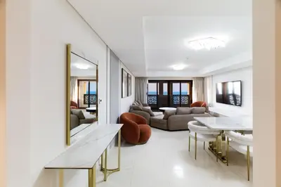 a living room with a table and a couch at Charming Sea View 2BDR, Beach and Pool Access in Dubai