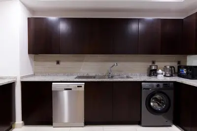 a kitchen with a washing machine and a sink at Charming Sea View 2BDR, Beach and Pool Access in Dubai