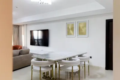 a dining room with a table and chairs at Charming Sea View 2BDR, Beach and Pool Access in Dubai