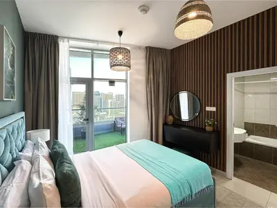 a bedroom with a large bed and a bathroom at Trophy - Luxury Waterfront 2BR with Big Terrace Full Marina Canal Views in Dubai