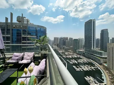 a balcony with purple pillows and a view of a harbor at Trophy - Luxury Waterfront 2BR with Big Terrace Full Marina Canal Views in Dubai