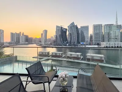 a balcony with chairs and a view of a city at Sunset View Overlooking Burj Khalifa and Canal View in Dubai