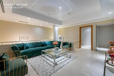 a living room with a green couch and a table at Usmans Brand New Duplex Apartment 5 Bedrooms Dubai Marina Trident Bayside 4 Rooms with 4 En-suite Washrooms in Dubai