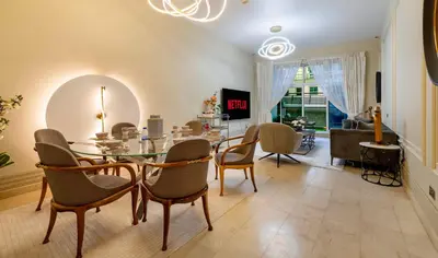 a dining room with a table and chairs at Usmans Brand New Duplex Apartment 5 Bedrooms Dubai Marina Trident Bayside 4 Rooms with 4 En-suite Washrooms in Dubai
