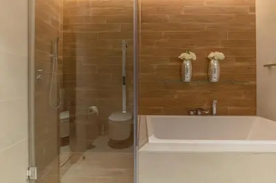 a bathroom with a bath tub and a toilet at 2BDR Apartment in Bluewaters Luxury Area in Dubai