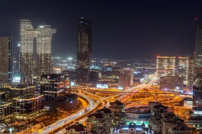a city lit up at night with traffic at 3 Bedrooms Apartment in Downtown Views - Dubai Burj Khalifa View in Dubai