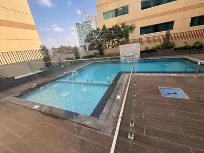 a swimming pool in the middle of a building at White Sage New Large 1BR at JVC in Dubai