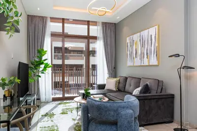 a living room with a couch and a table at White Sage New Large 1BR at JVC in Dubai