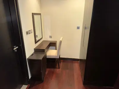a dressing room with a mirror and a white chair at Royal Amwaj-Anantara residence South in Dubai