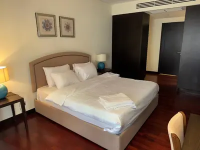 a bedroom with a bed with white sheets and pillows at Royal Amwaj-Anantara residence South in Dubai