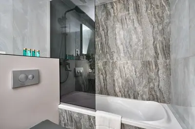 a bathroom with a bath tub and a shower at Frank Porter - Marina Quays East Tower in Dubai