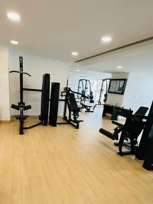a gym with several treadmills and machines in a room at Cityview Haven 1BR Modern Flat in Bloom Heights in Dubai
