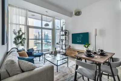 a living room with a couch and a table at ShoresInn - A sublime stay in Dubai Marina in Dubai