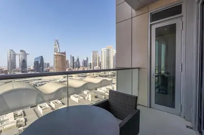 a balcony with a table and a view of the city at Downtown Elegance - 1BR Apartment with Unmatched Burj Khalifa Views in Dubai