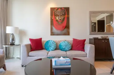 a living room with a couch and a table at Downtown Elegance - 1BR Apartment with Unmatched Burj Khalifa Views in Dubai