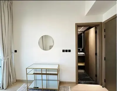 a hallway with a glass table and a mirror at Binghatti Heights JVC in Dubai