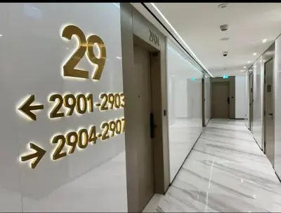 a hallway in a building with a sign on the wall at Binghatti Heights JVC in Dubai
