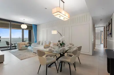 a living room with a table and a couch at Exceptional high floor 3bed apartment by Suiteable in Dubai